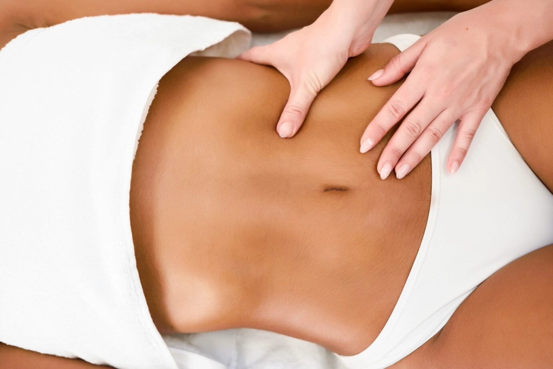 Toned abdomen receiving body sculpting therapy.