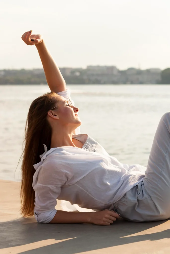 Woman stretching outdoors, embracing wellness and calm.